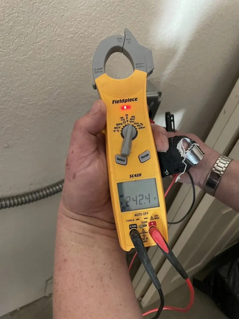 Voltage testing with clamp meter during Outlet Installation in Brookfield